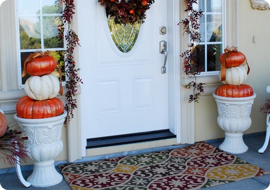 pair of urns with pumpkins