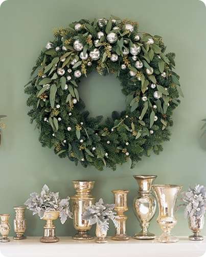 Create this glittering decoration by trimming a noble fir wreath with silvery ornaments and sprigs of seeded eucalyptus.