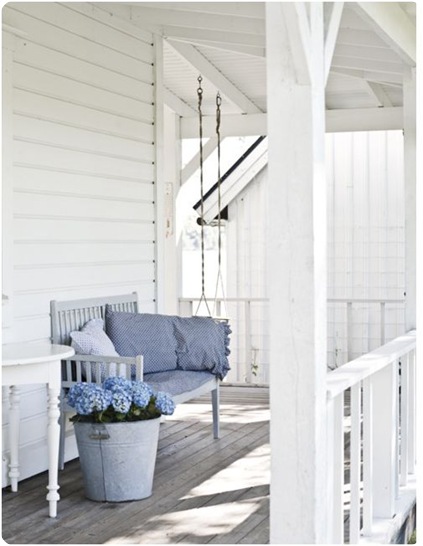 white porch blue hydrangeas