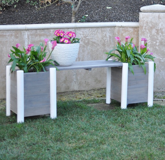 gray and white bench with planters