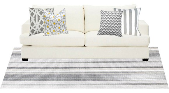 gray and white rug and pillows on sofa