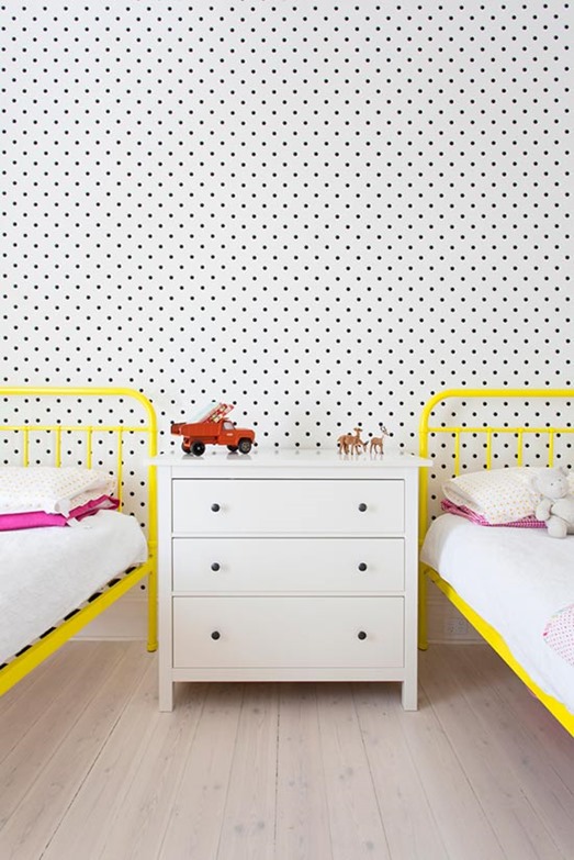 yellow beds and polka dot wall