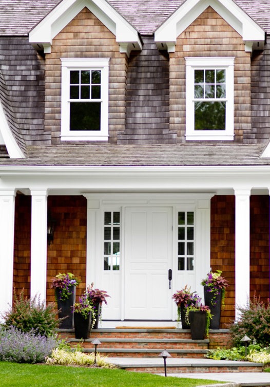shingle exterior with porch and planters