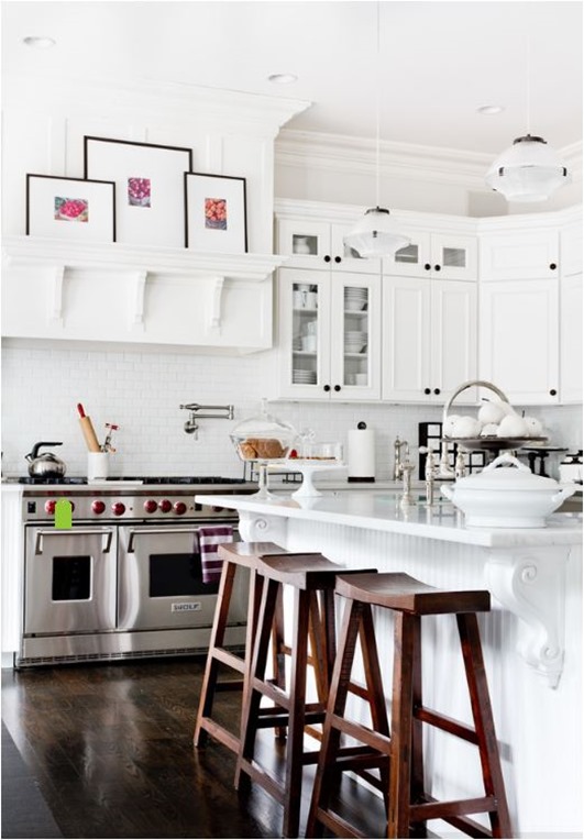 white kitchen dark floors and barstools