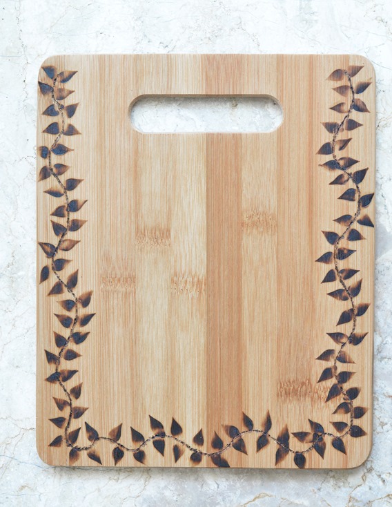 wood burned cutting board with leaf pattern