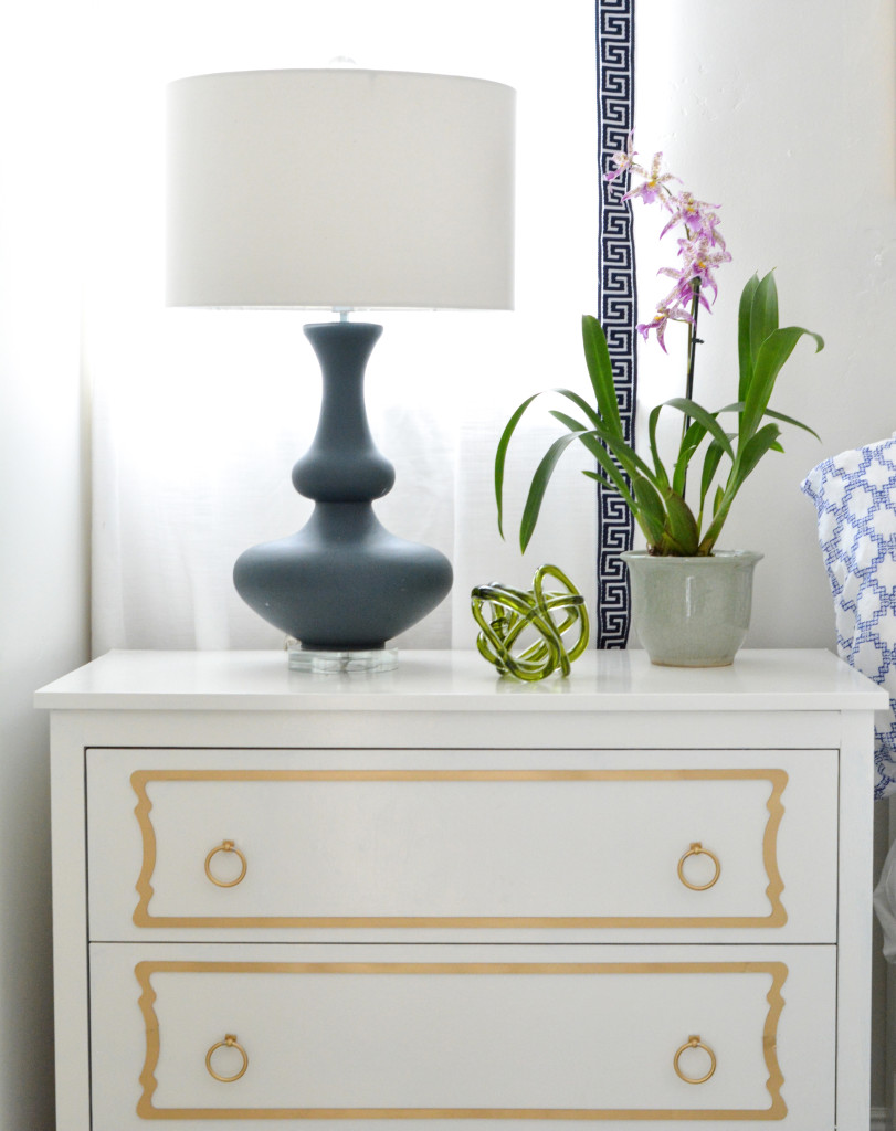 white dresser with overlays navy lamp