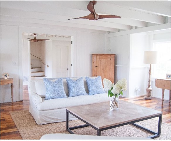 coastal living room with wood ceiling fan